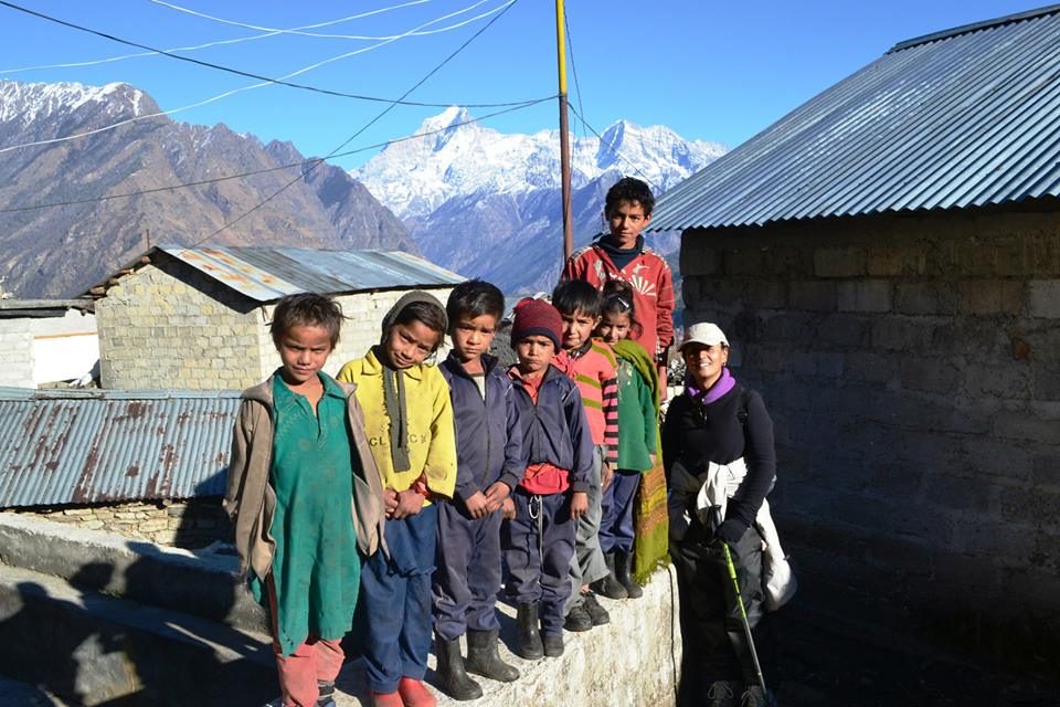 With a bunch of cheerful bunch of kids in the village